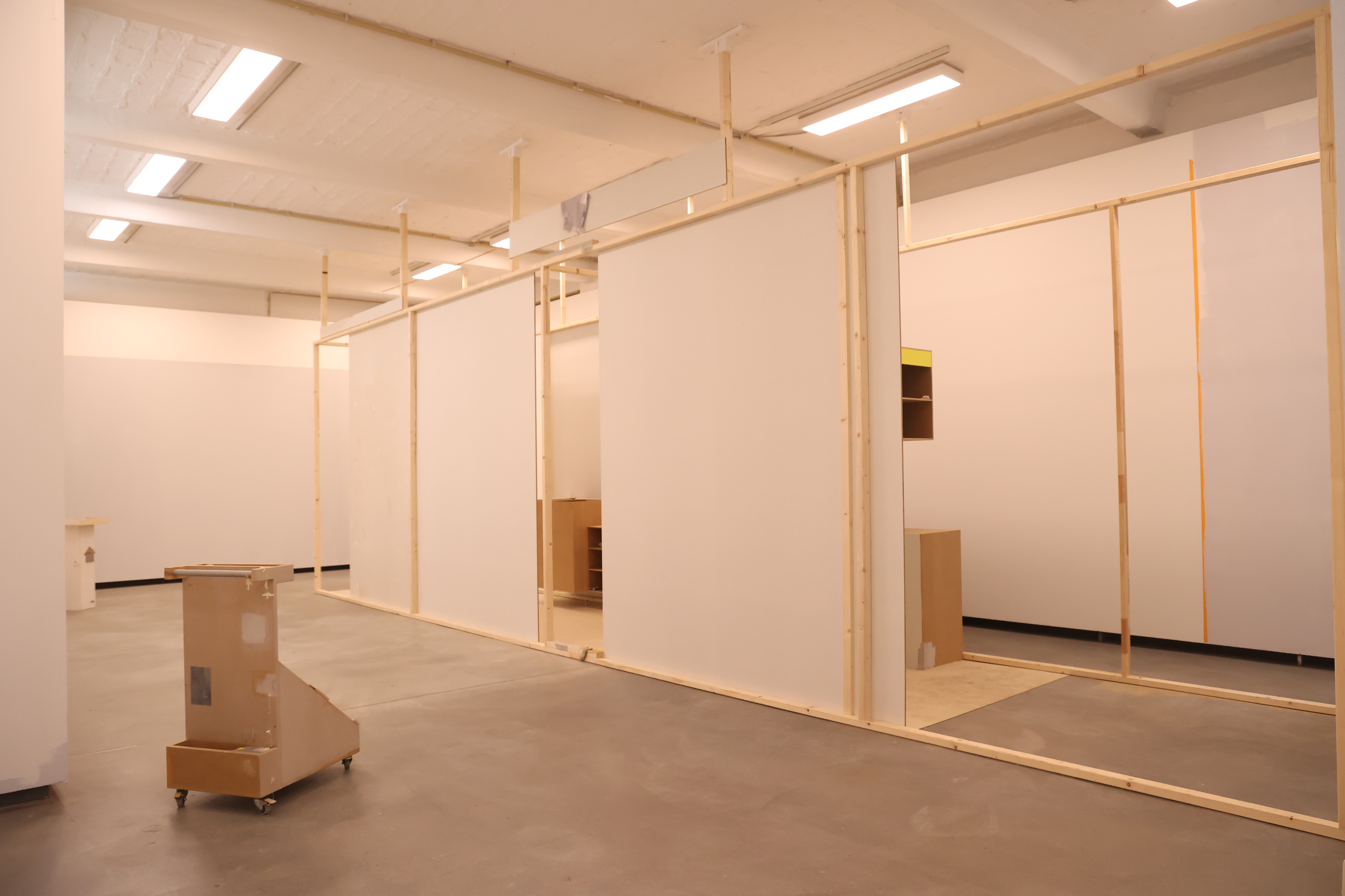 Sara Wu · Installation view with wooden frames and sculptures